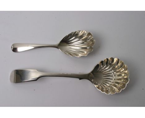 A silver caddy spoon and a silver sugar caster of shell form