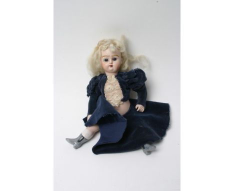 A small bisque doll in blue dress