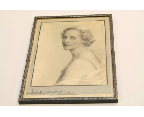A portrait of Dorothy wilding with with facsimile signature
