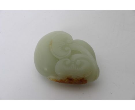 A Chinese Celadon jade carving with some russet colouration in the form of a double gourd with raised lingzhi