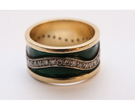 A gold and green enamel ring set with a swirling pattern of diamonds