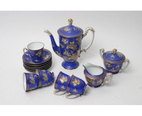 A Noritake porcelain coffee set decorated with gilt on deep blue ground 