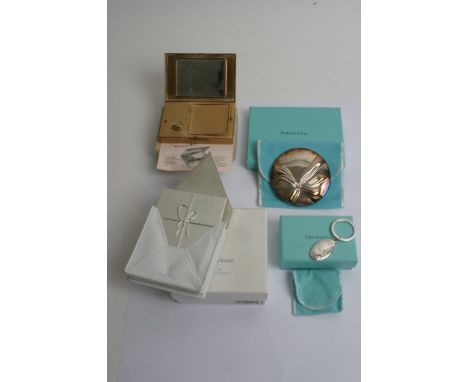 A musical compact, another by Vera Wang, a boxed Tiffany keyring and mirror
