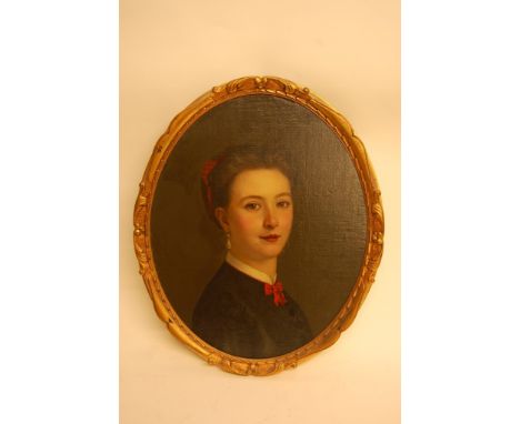 A gilt framed oval shaped oil painting on board depicting the portrait of a young lady with inscription to the reverse