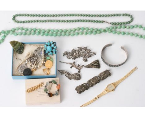 A collection of jewellery including two yellow metal brooches, green hardstone necklaces (possibly jade) and various costume 
