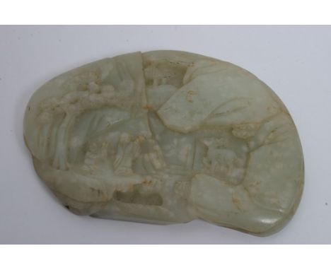 A Chinese jade panel carved in the Cantonese style with figures, trees and deer. Length: 10.5cm approximately