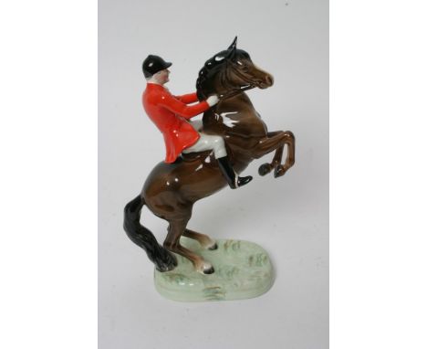 A Beswick rearing horse and rider in hunting attire