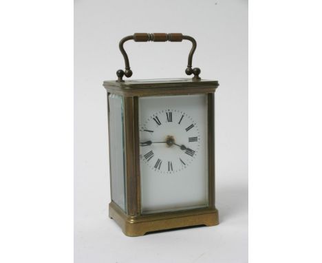 A brass cased carriage clock with an enamel dial 