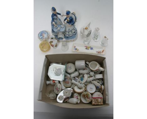 A box containing a collection of decorative ceramics and glassware including figures and trinket boxes