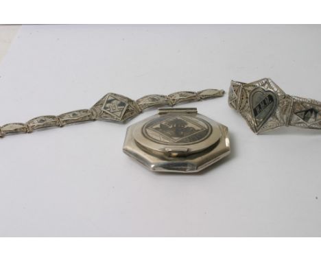 Two white metal filigree and niello bracelets together with a white metal and niello powder compact