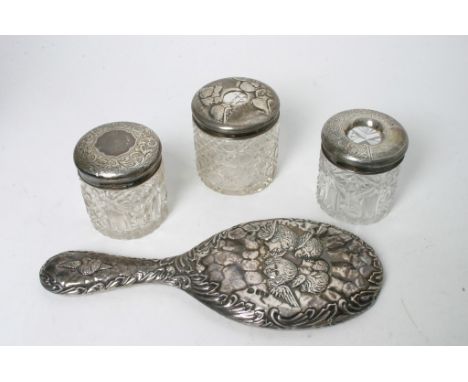 Two silver top tidy jar, a trinket jar and a silver hand mirror 