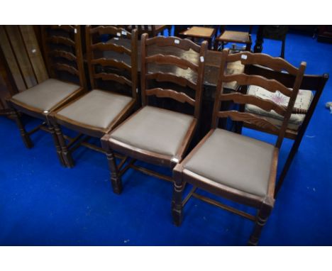 A set of four vintage stained frame ladderback dining chairs