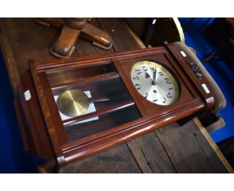 A 1920s wall clock having silvered dial