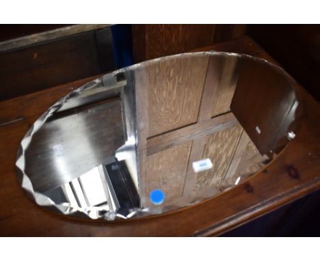 A vintage frameless wall mirror