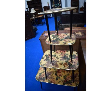 A kitsch vintage nest of four table with floral design and dansette style legs, light wear only