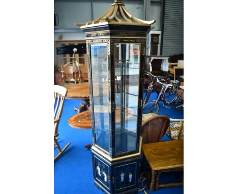 An Oriental pagoda style laquer and giltwork display cabinet with mother of pearl relief decoration to base.
Structually soun