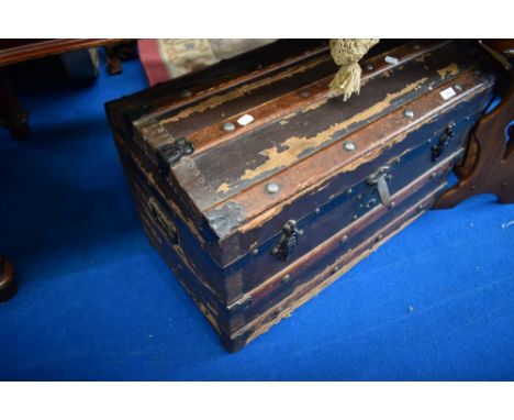 A vintage dome top travel trunk