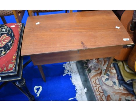 A vintage teak sewing table