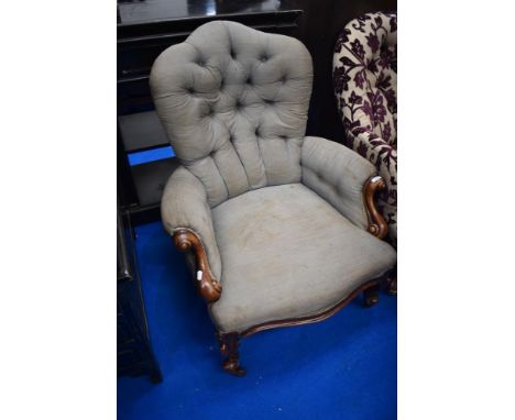 A Victorian easy chair having mahogany knurl frame and button back
