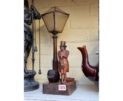 An early 20th century novelty carved wood figural table lamp, representing a Dickens style figure, possibly Mr Micawber, heig