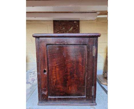 An antique mahogany wall mounted post box, 27cm wide; together with a Balinese carved wood panel. 