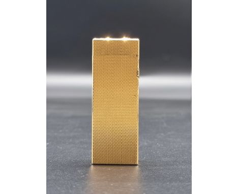 A Dunhill gilt lighter, model 15050, (dents). 
