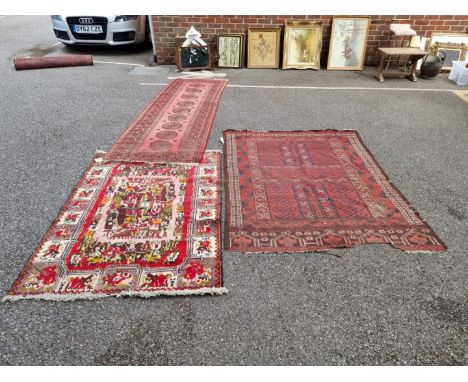 A Bokhara runner,&nbsp;having nine central medallions, 200cm x 89cm; together with a Bokhara rug, 176cm x 138cm; and one othe