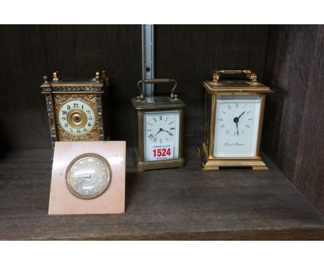 Three brass carriage timepieces, largest 14.5cm high; together with another vintage easel back timepiece. (4) 