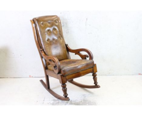 19th century Mahogany Framed Rocking Chair with button brown leather upholstery and scrolling arms, 54cm wide x 86cm deep x 1