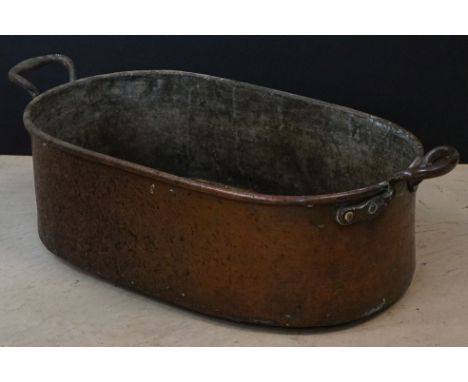Antique Copper Oval Twin Handled Cooking Pot, stamped 55 with an arrow to side, 70cm long x 22cm high 