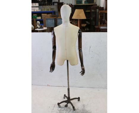 Male Shop Mannequin with cloth covered head and body, wooden articulated arms and hands, mounted on an industrial style metal