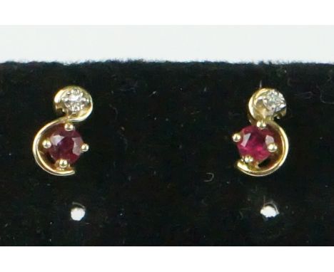 Pair of yellow gold ruby and diamond stud earrings 