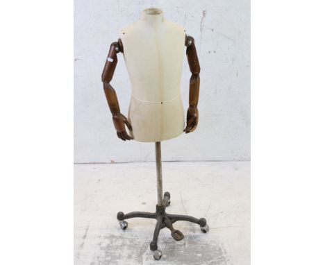 Child Shop Torso Mannequin with cloth covered head and body, wooden articulated arms and hands, mounted on an industrial styl