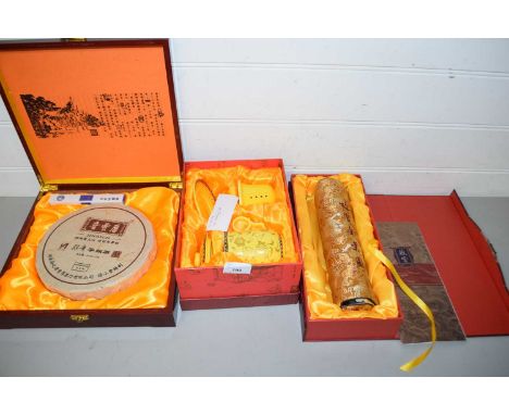 Boxed Jinrich Chinese tea block together with a further modern Chinese scroll picture and a boxed modern Chinese tea steeping