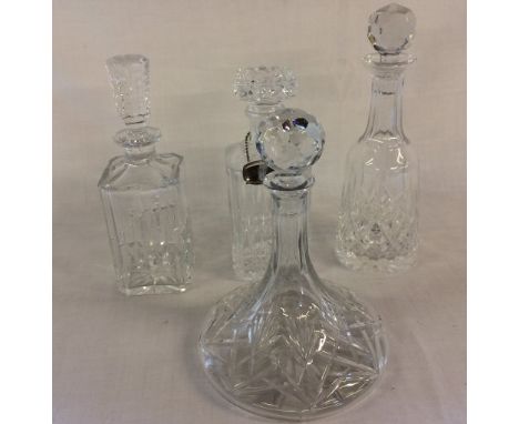 4 glass decanters (one with wrong stopper) & a silver plate Scotch label