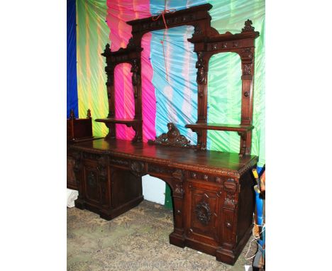 A huge 19th c. Oak mirrorback twin pedestal Gothic inspired Sideboard, with carved and fret cut stylized Acanthus design pedi