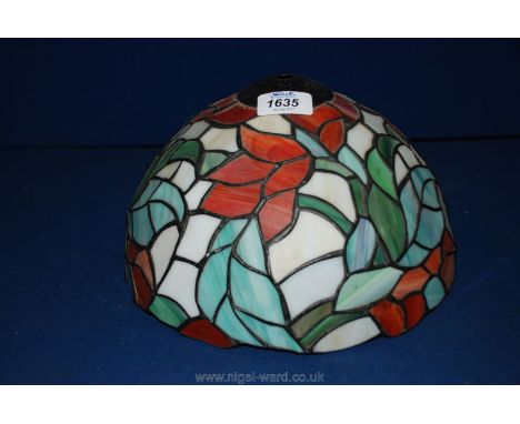 A Tiffany style lamp Shade with red flowers.