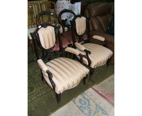 A pair of late 19th c. Mahogany Salon elbow Chairs, the carved top rail over back pad in fret-cut pierced support on similar 