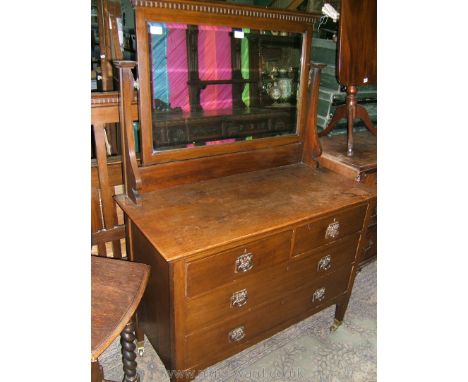 An Art Nouveau Oak Dressing Chest, with rectangular bevel plate mirror in frame with moulded top and castellated detail in sh
