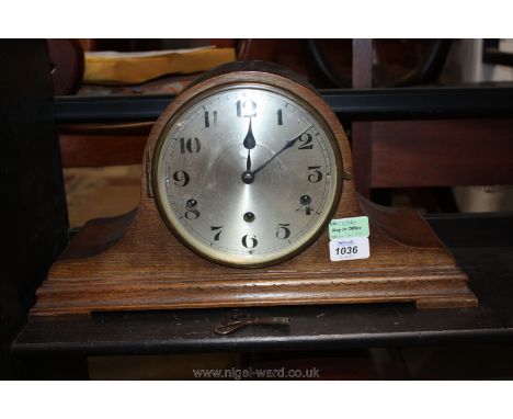 A three train Westminster chiming mantle Clock, with pendulum and key