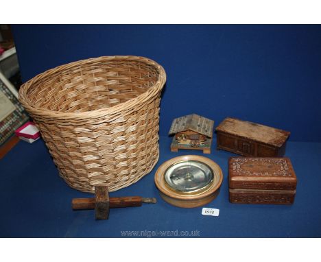 A wicker basket containing circular barometer, scribe tool, wooden boxes, etc.