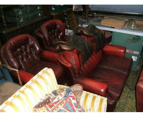 A modern deep red Leather three piece Lounge Suite comprising two seater wing back Sofa, wing back Armchair and fireside Armc