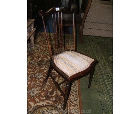 An Arts and Crafts stained Beech Bedroom Chair with shaped top rail on turned supports with stick back, applied regency strip