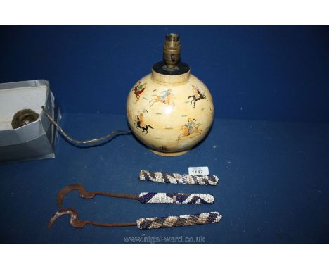 A papier mache Table Lamp decorated with polo players and three hooks with beadwork handles