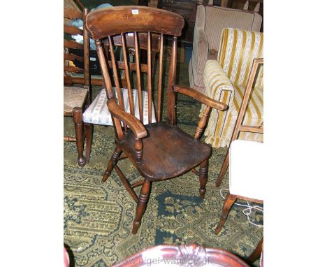 A 19th c. Elm seat stick back Grandfather chair, with shaped top rail on spoke shaved supports and swept arms on turned suppo