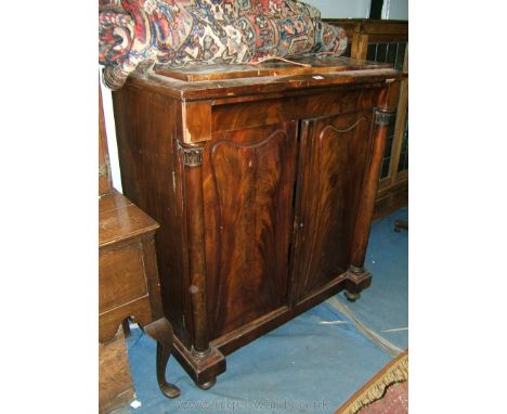 A substantial mid 19th c. Walnut Linen Cupboard of caddy style on Corinthian style columns with carved tops, flanking the con