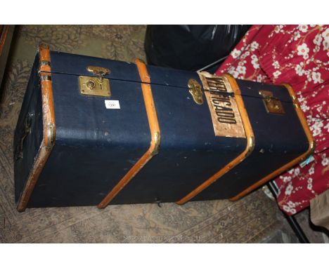 A blue covered Steamer Trunk with wooden strips