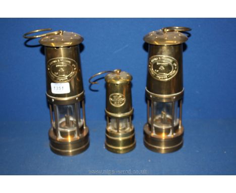 Three Miner's lamps including two Cambrian (nos. 35417 and 68040) by E. Thomas & Williams Ltd, Aberdare and a smaller musical
