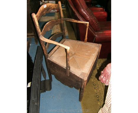 A late 18th/early 19th c. Ash ladder-back Commode Chair, the three shaped bar back in turned supports and shaped arms, also o