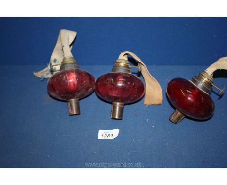 Three Cranberry glass Oil lamp Reservoirs with burners.